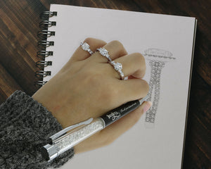 Unique engagement rings adorn a drawing hand. Custom Diamond Drawing Rendering CAD Design. 